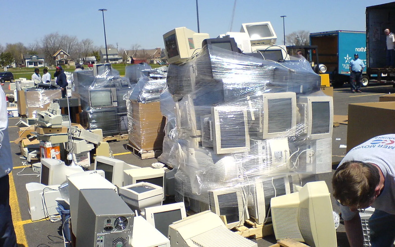 Old computers and monitors stacked for electronics recycling