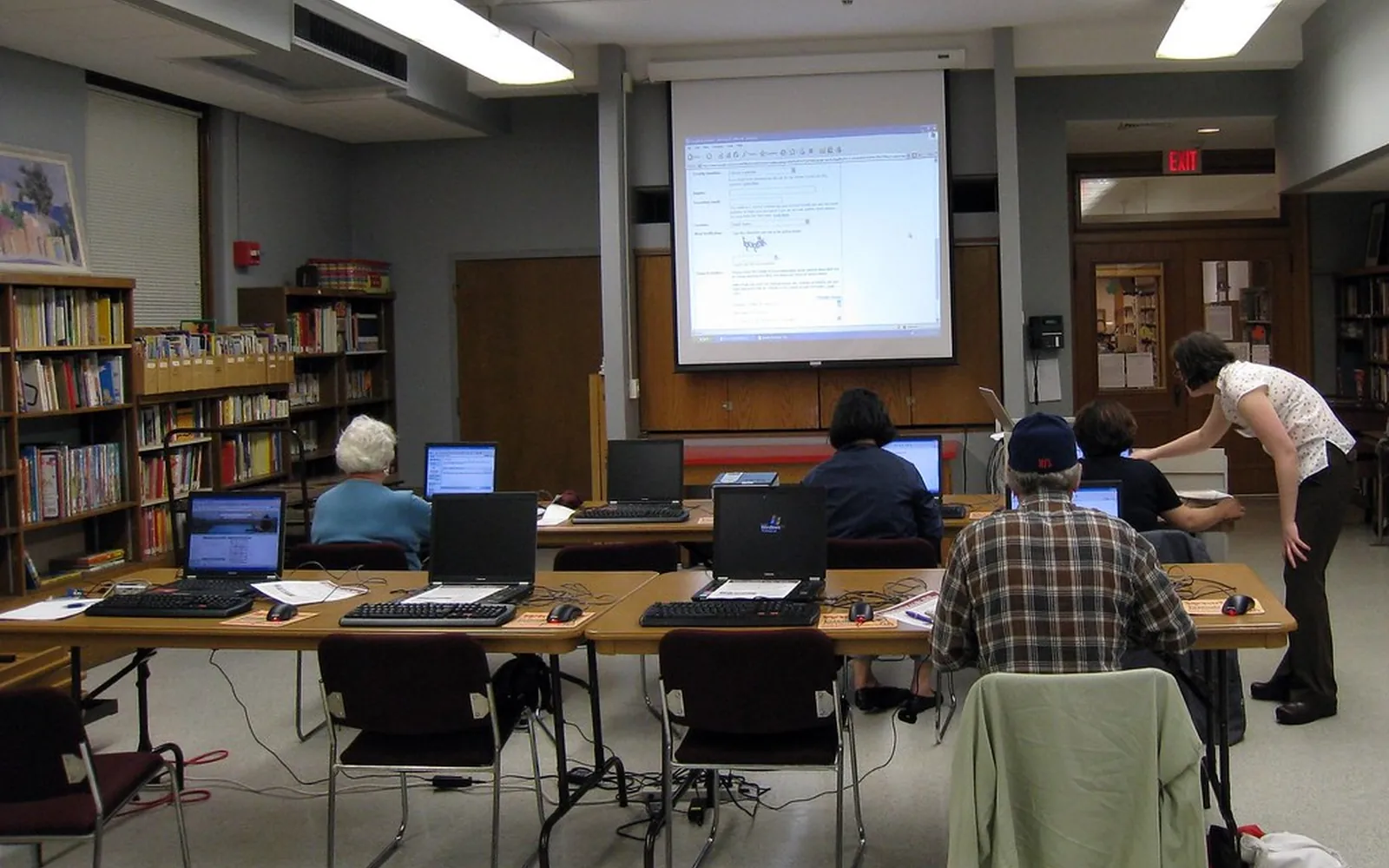 Adults at a free internet class in a public library computer room