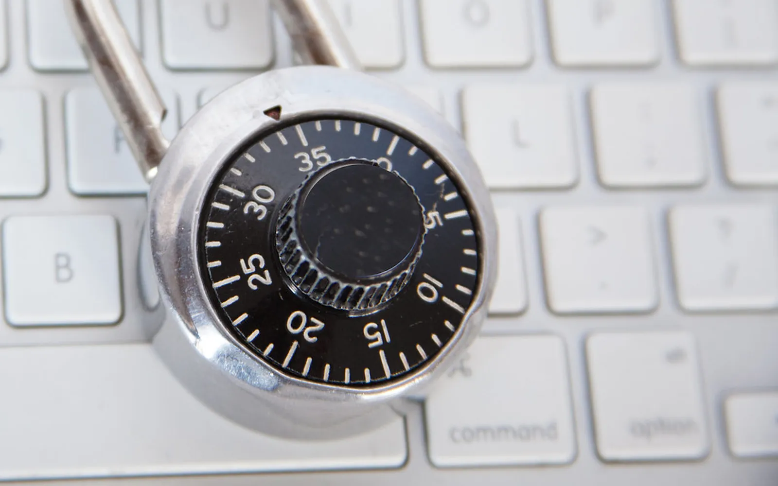A combination padlock lying on a computer keyboard